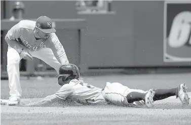  ?? AP Photo/Orlin Wagner ?? ■ Houston Astros' Jose Altuve (27) is tagged out while trying to advance on a sacrifice fly by Kansas City Royals third baseman Mike Moustakas (8) during the first inning of a baseball game Saturday at Kauffman Stadium in Kansas City, Mo.