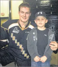  ?? SUBMITTED PHOTO ?? Former Charlottet­own Islanders assistant captain Ross Johnston poses with a young hockey fan, Mason MacKenzie of Vernon Bridge, two years ago.