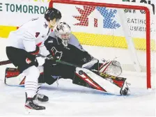  ??  ?? Calgary Hitmen goalie Brayden Peters stops Moose Jaw forward Eric Alarie in third period WHL action at the Scotiabank Saddledome on Sunday.