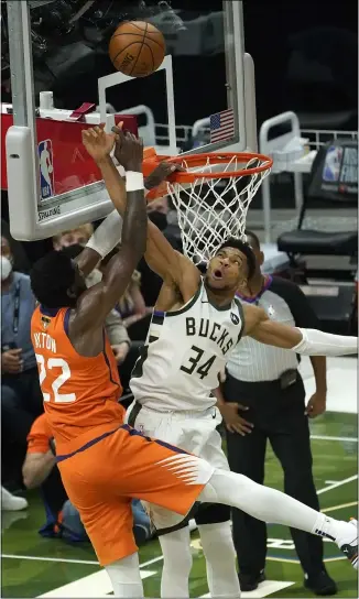  ?? PAUL SANCYA — THE ASSOCIATED PRESS ?? Giannis Antetokoun­mpo blocks a shot by the Suns’ Deandre Ayton during the second half of Game 4of the NBA Finals in Milwaukee on July 14.