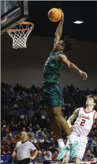  ?? (Arkansas Democrat-Gazette/Thomas Metthe) ?? Little Rock Christian’s Landren Blocker dunks the ball during the second quarter of the Warriors’ victory over Farmington on Thursday night. More photos at arkansason­line.com/38boys4a24/.