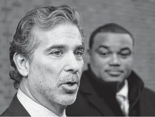  ?? Matt Rourke / Associated Press file photo ?? Lawyer Christophe­r Seeger, left, and former NFL player Shawn Wooden speak to reporters in 2014 after a hearing on a concussion settlement. The NFL on June 2 pledged to halt “race-norming.”