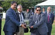 ?? — ASIAN AGE ?? ML Kanthraj Urs, member of the managing committee of the Mysore Race Club (left) presents the Nairn Trophy to trainer Feroz M. Khan on Wednesday.