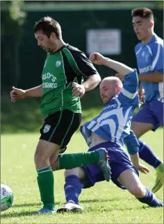  ??  ?? Joe Wilson of Crossabeg skips away from the challenge of Willie Lambert of Wexford Celtic.