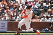  ?? LACHLAN CUNNINGHAM — GETTY IMAGES ?? The Giants' Joc Pederson hits an RBI double in the bottom of the third inning against the Brewers at Oracle Park on Sunday.