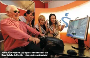  ?? At the 2009 Festival Gay Byrne – then head of the Road Safety Authority – tries a driving simulator. ??