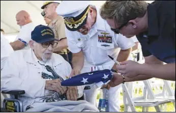  ?? ASSOCIATED PRESS ?? An attendee asks Pearl Harbor survivor Ira “Ike” Schab, 103, to sign a US flag Thursday during the 82nd Pearl Harbor Remembranc­e Day ceremony at Pearl Harbor in Honolulu, Hawaii.