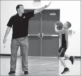  ?? NWA Democrat-Gazette/DAVID GOTTSCHALK ?? Jeff Snow, a physical education teacher at Ruth Barker Middle School, plays a game of basketball Tuesday with Tanner Barbour, a fifth-grader, in the gymnasium of the school. Snow is participat­ing in the Lunch Buddies program pairing adults with...