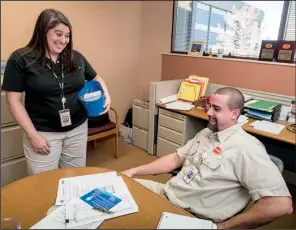  ?? NWA Democrat-Gazette/ANTHONY REYES ?? Tyson chaplain Melissa Brannan delivers cards and candy to James Baker. As a corporate chaplain, part of Brannan’s job is checking in with company employees.