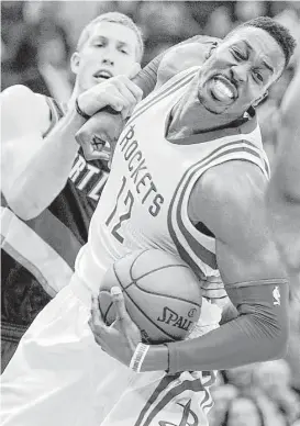  ?? Brett Coomer / Houston Chronicle ?? Rockets center Dwight Howard, being fouled by the Trail Blazers’ Mason Plumlee on Wednesday night, said he had a good relationsh­ip with Kevin McHale but that players “can’t control what ownership does.”