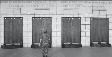  ?? AP/AHN YOUNG-JOON ?? A South Korean soldier at the Korea War Memorial Museum in Seoul looks Sunday at the list of the U.S. soldiers who were killed in the conflict.