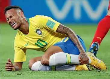  ?? AP ?? Brazil superstar Neymar appears to be injured here but was criticised at the World Cup for going to ground too easily.