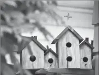  ??  ?? Ken Wilson built some birdhouses for his backyard garden.