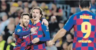  ?? JOAN MONFORT THE ASSOCIATED PRESS ?? Barcelona's Lionel Messi, left, celebrates after scoring his side's second goal with Antoine Griezmann, during a Champions League game between Barcelona and Dortmund Wednesday.