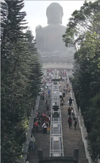  ?? PHOTOS: SUZETTE LABOY/THE ASSOCIATED PRESS ?? A climb of 268 steps takes visitors to the Tian Tan Buddha statue in Ngong Ping Village, which is also home to the Po Lin Monastery.