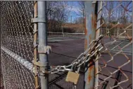  ?? (Arkansas Democrat-Gazette/Colin Murphey) ?? A lock and chain keeps the gate secured at the tennis courts located near the swimming pool in the Indian Hills neighborho­od of North Little Rock on Saturday. The Indian Hills Community Club has pushed a proposal to have the neighborho­od pay for the upkeep of the tennis courts and pool.