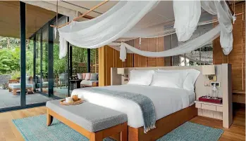  ??  ?? The bedroom in a suite at Six Senses Krabey Island.