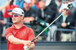  ?? ANDY BUCHANAN/AFP/GETTY IMAGES ?? Top U.S. golfer Zach Johnson watches his shot on Day 3 of the 147th Open golf Championsh­ip at Carnoustie, Scotland, last month. But another Zach Johnson will share golf’s spotlight this week.