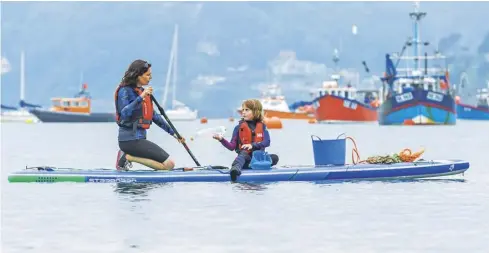  ??  ?? Anna and Ella Turns pick litter from the sea in the Salcombe Estuary