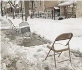  ?? SUN-TIMES FILE ?? These folding chairs were used after a past snowstorm to reserve a spot in the Bridgeport neighborho­od.