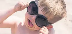  ?? Bottom picture: Alan Richardson. ?? Life’s a beach: Students enjoying Kinghorn beach while Dominic Richards, 4, looks cool at Broughty Ferry wearing his mum’s shades.