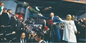 ?? AP/BURHAN OZBILICI ?? Turkey’s President Recep Tayyip Erdogan and his wife, Emine Erdogan, throw carnations toward supporters Sunday during a congress of the ruling Justice and Developmen­t Party in Ankara, Turkey.