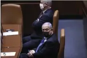  ?? ALEX KOLOMOISKY — POOL ?? Israeli Prime Minister Benjamin Netanyahu, front, attends the swearing-in ceremony for Israel’s 24th government at the Knesset, or parliament, in Jerusalem on Tuesday.