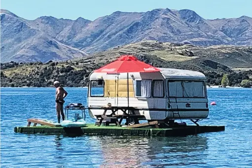  ?? PHOTO: JEFF DONALDSON ?? Water view . . . Glendhu Bay Motor Camp manager Phil Hunt ‘‘camps’’ in the middle of Lake Wanaka yesterday.