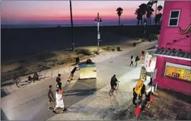  ?? Mel Melcon Los Angeles Times ?? THE RESTROOMS added to Venice Beach could open by the end of the month. Above, a man wheels his portable home along the Venice Beach boardwalk in 2016.