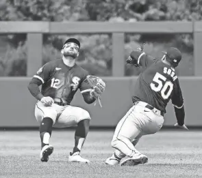  ?? ERIC HARTLINE/USA TODAY SPORTS ?? Chicago White Sox outfielder Kevin Pillar, left, prepares to catch fly ball as third baseman Lenyn Sosa gets out to the way during a game against the Phillies on Sunday in Philadelph­ia.