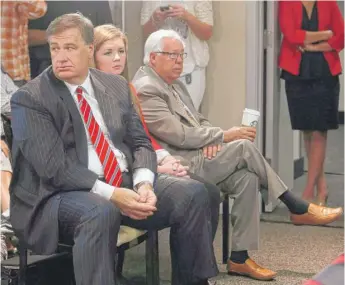  ?? JEFF MCINTOSH/THE CANADIAN PRESS VIA AP ?? Calgary Flames owners group members Murray Edwards (left) and Clay Riddell, listen as newly named Calgary Flames President of Hockey Operations Brian Burke is annouced in Calgary, Alberta, in 2013.
