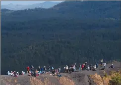  ?? (AP/Eduardo Verdugo) ?? A group belonging to an internatio­nal vulcanolog­y congress rests Feb. 22 on the crater lip of the Paricutin volcano in Mexico.