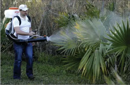  ?? PAT SULLIVAN — THE ASSOCIATED PRESS ?? In this Feb. 10 photo, Darryl Nevins, owner of a Mosquito Joe franchise, sprays a backyard to control mosquitoes, in Houston. Pest control companies in Texas are getting an early surge in business because of concerns that mosquitoes bearing the Zika...