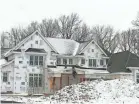  ?? PAUL GORES / MILWAUKEE JOURNAL SENTINEL ?? Crews work on a luxury home being constructe­d in Brookfield.