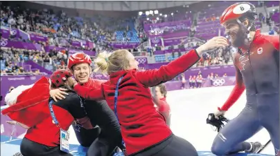  ?? AP PHOTO/BERNAT ARMANGUE ?? Canadian skaters Pascal Dion, left, and Charles Hamelin of Canada celebrate with teammates after winning the bronze medal in the men’s 5,000-metre