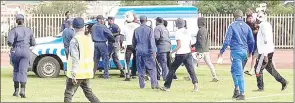  ?? (Pics: Sanele Jele) ?? Mbabane Highlander­s fans baying for the referee’s blood as they followed the police van that he was in.