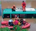  ?? AP ?? SubmErgEd buS: rescue workers evacuate passengers on a boat from a submerged bus in Paju, S. Korea. —