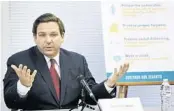  ?? BOB SELF/AP ?? Gov. Ron DeSantis, seen here at a roundtable discussion in Jacksonvil­le, also gave a TV interview where he said the state’s unemployme­nt system was designed before he took office with “pointless roadblocks” meant to get in the way of laid-off workers seeking benefits.