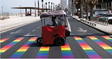  ?? (Reuters) ?? A SIDEWALK painted with colors for the gay pride parade in Tel Aviv. The author wonders why anti-Israel Jewish academics don’t support Israel’s gay rights and liberal values?