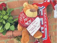  ??  ?? Teddies, scarves, flowers and football shirts are left