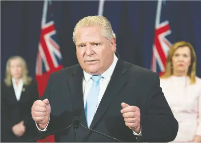  ?? NATHAN DENETTE/ THE CANADIAN PRESS ?? Premier Doug Ford, seen with Long-term Care Minister Merrilee Fullerton (Kanata-Carleton), left, and Health Minister Christine Elliott, has unveiled a budget he hopes will get the province through the COVID-19 crisis.