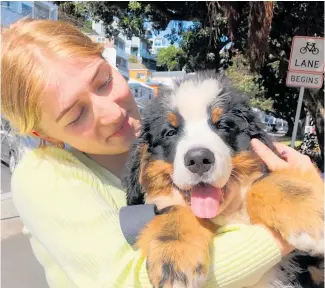  ?? Photo / Georgina Campbell ?? Bernie's on the Bay barista Georgia Gapes with puppy El Bernardo.