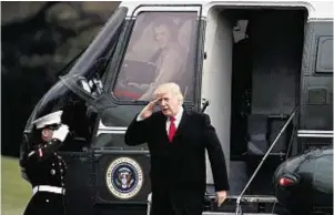  ??  ?? President Donald Trump salutes as he steps off Marine One at the White House