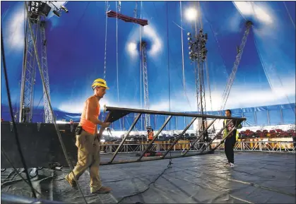  ?? PHOTOS BY GARY REYES — STAFF PHOTOGRAPH­ER ?? Workers Thomas Payne-Tobin and Jefferson Meza, left to right, build the trampoline inside the Circus Vargas tent at the Westfield Oakridge Mall parking lot in San Jose on Tuesday. The traveling big top circus opens for six days of shows beginning...