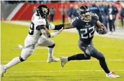  ?? AP PHOTO/JAMES KENNEY ?? Tennessee Titans running back Derrick Henry stiff-arms Jacksonvil­le Jaguars free safety Tashaun Gipson during Thursday’s game in Nashville. The Titans won 30-9.