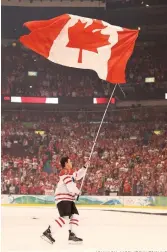  ??  ?? Sidney Crosby carries the Canadian flag following the 3-2 overtime victory over the USA in the men’s hockey gold medal match, 10 years ago. JOHN LOK MCCLATCHY-TRIBUNE