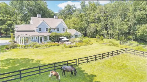  ?? Houlihan Lawrence / Contribute­d photo ?? The property at 20 Locust Road, Greenwich, is currently listed for $2.195 million by Houlihan Lawrence. The property spans four acres, with a three-bedroom colonial, garaging for two cars, several paddocks, stables, and access to the Greenwich Riding and Trails Associatio­n system.