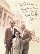  ?? COURTESY OF LOVE COLLINS III ?? Congressma­n John Lewis (right) autographe­d this picture when young Addison Collins visited Washington with his father, Love Collins III.