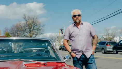  ?? Photos by Timothy O’connell, © The New York Times Co. ?? Guy Fieri with his red Camaro in northern New Jersey while filming “Diners, Drive-ins and Dives” on April 1.