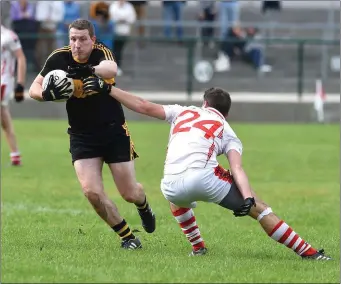  ??  ?? Andrew Kenneally Dr Crokes avoids the challenge of Mark T Reen Rathmore in the Molyneaux Cup final at Rathmore on Saturday.